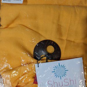 Yellow/gold beach sarong with coconut sarong 'buckle'